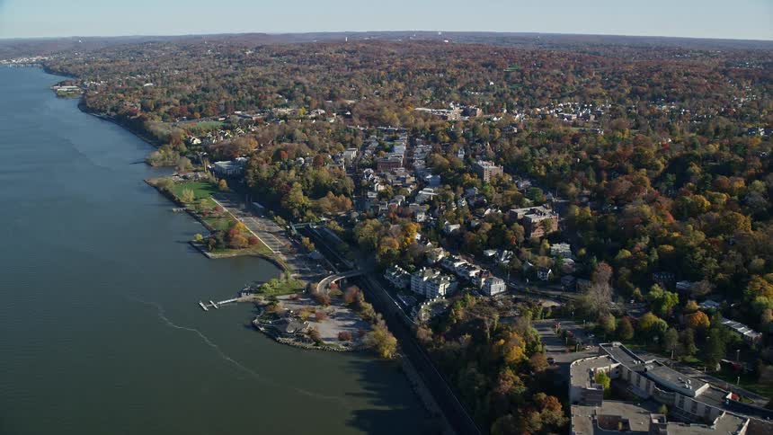 Aerial panorama of an urban city amidst trees and by the seaside