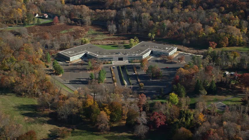 An aerial view of an architecture close to the wood forest