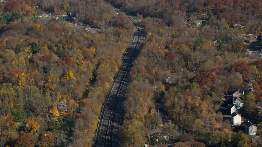 Aerial view of a highway amidst residential neighborhoods and extensive vegetation