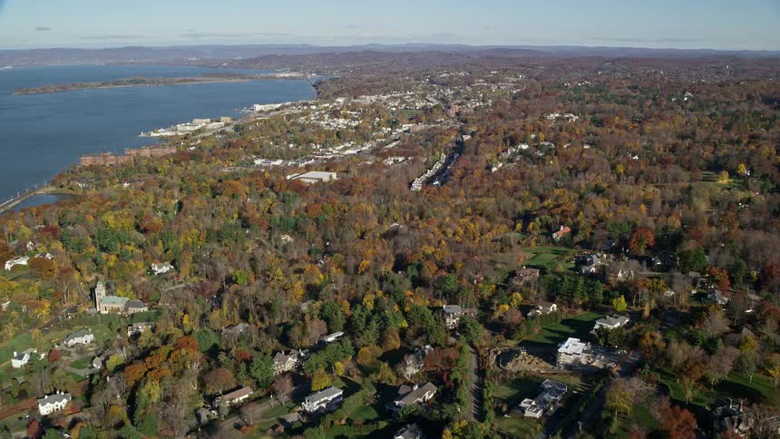 An aerial view of a rural community golf field and the sea