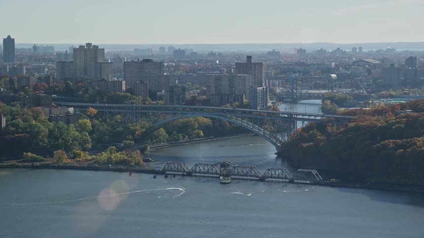 A large bridge that passes over a river in a city