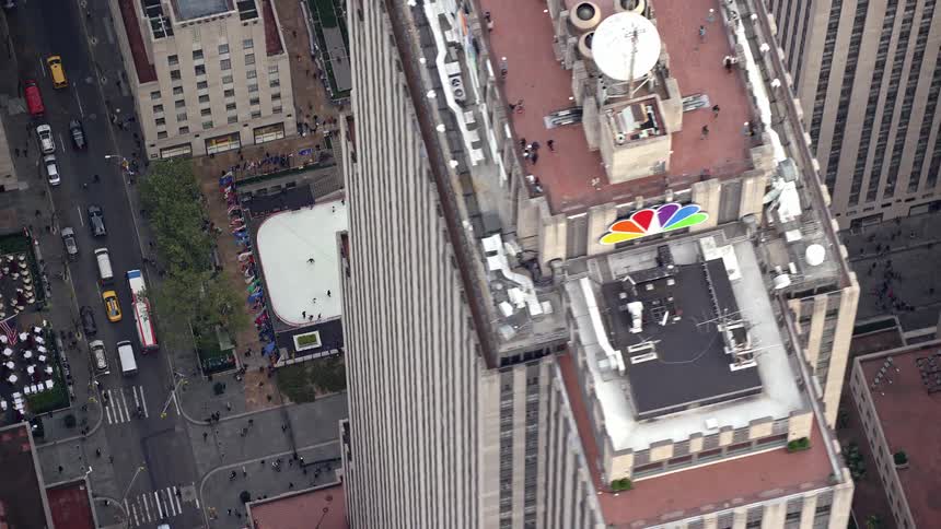 Aerial of a group of people skating on a skating rink in the city