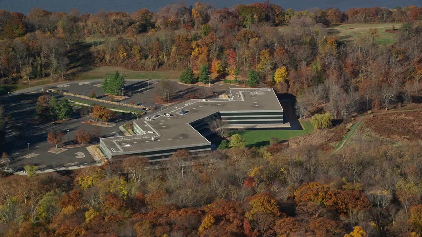 Autumnal forest surrounds office building set near water