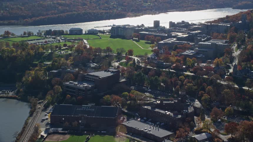 Aerial panorama of a city with apartments blocks and sports areas by the edge of a lake