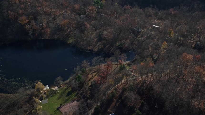 Aerial view of houses around a lake in a rural area