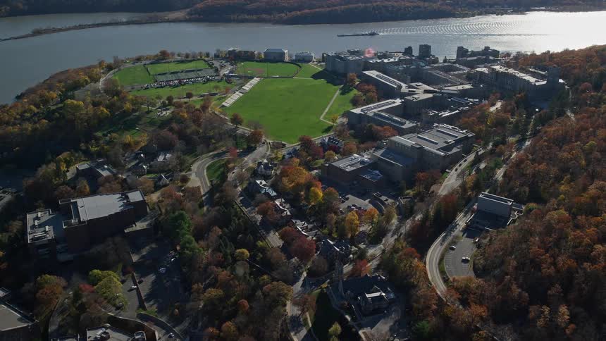Aerial view of a city by the seaside with fields and lawns