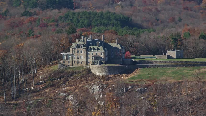An old mansion on a hill and several trees around it