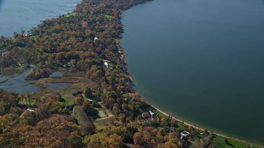 A region of land with many trees and surrounded by water