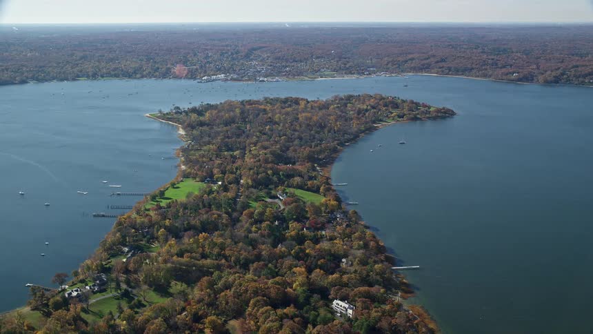 Aerial of wooded residential neighborhood situated on peninsula