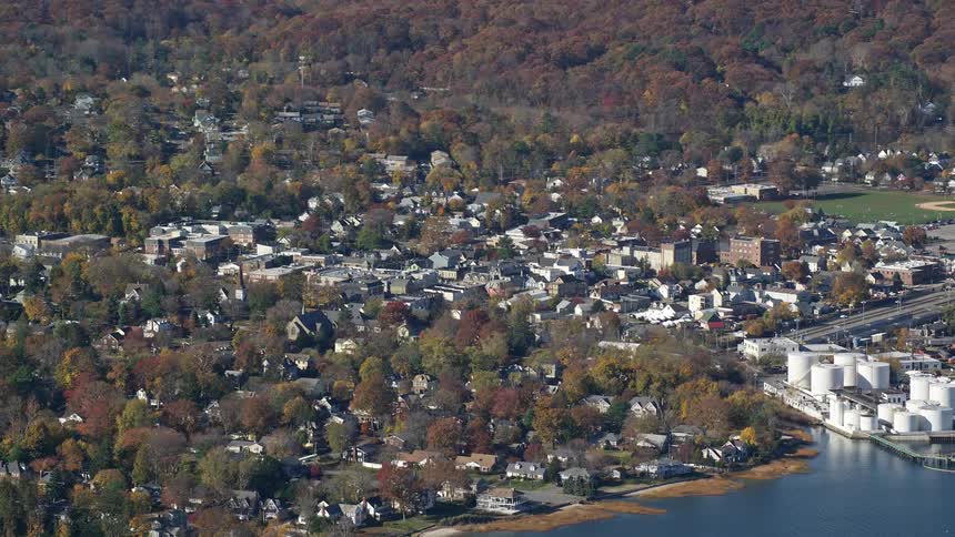 A residential area on the seafront with many trees