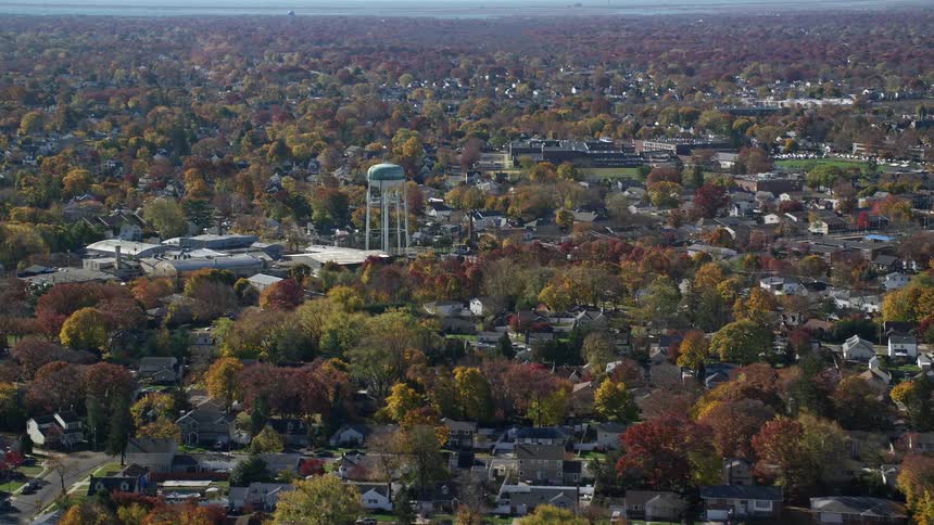 A sub urban town with building surrounded by trees