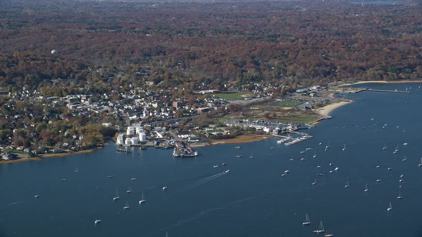 Aerial panorama of the sea with yachts and next to it an urban city