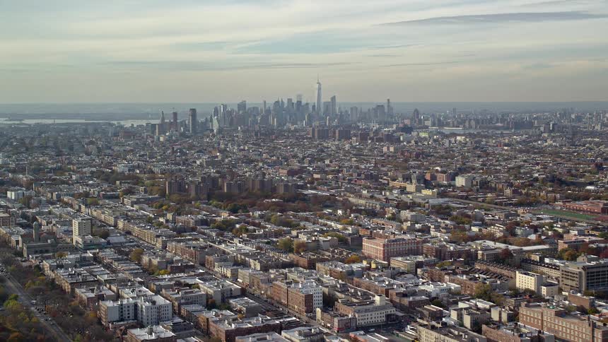 A residential area of a city and at the bottom there is a neighborhood with very tall buildings