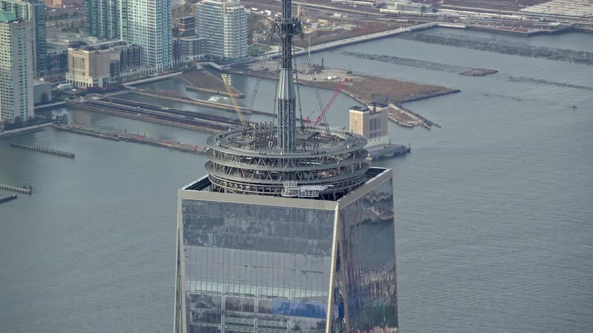 Surface of one world trade center reflects surroundings near waterfront