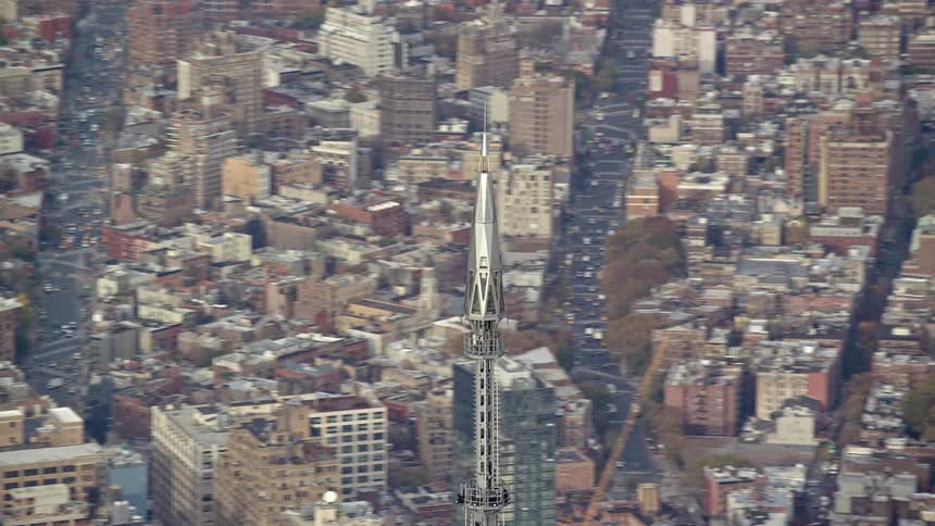 A large metal tower in the middle of a city