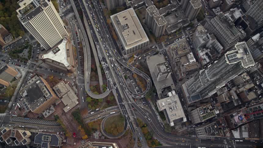 A large modern city with artistic roads that are very busy