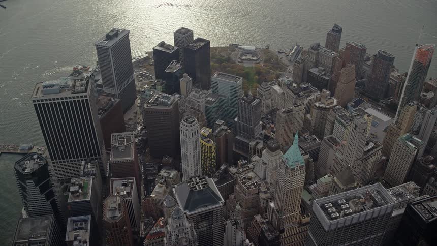 Aerial view of skyscrapers by the seaside with the morning suns reflection