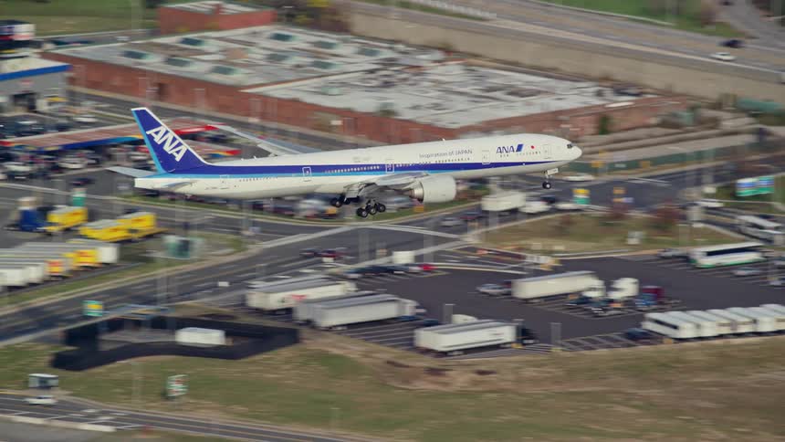 An aerial view of a plane landing at the airport