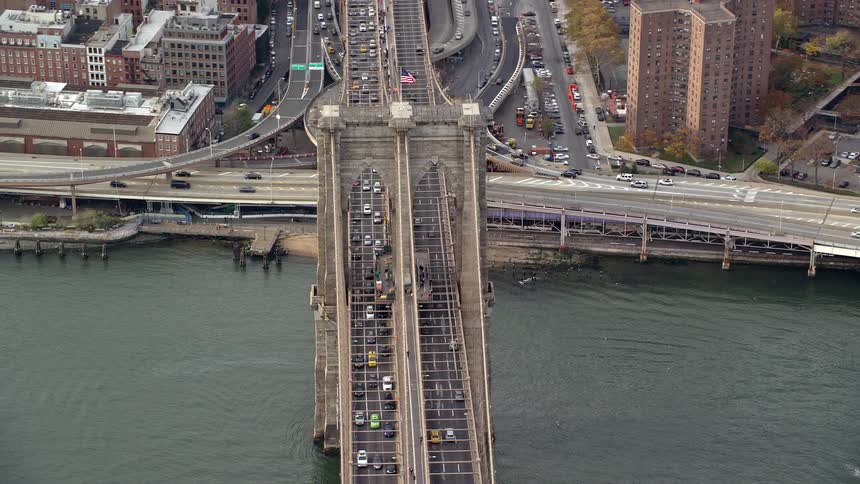 Aerial of the brooklyn bridge with heavy traffic at dawn