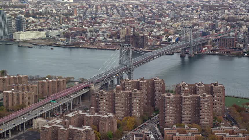 Aerial view of a bridge connecting a metropolis on the waterfront