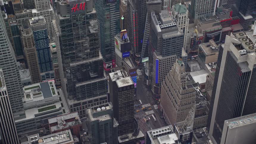 Aerial view of a metropolitan city with skyscrapers and billboards