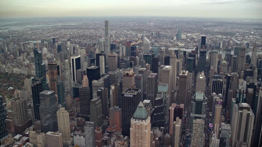 Aerial view of a metropolis during the day with skyscrapers by the seaside
