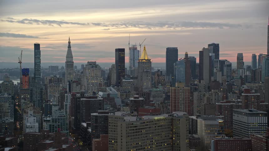 An aerial view of a metropolitan city with tall buildings