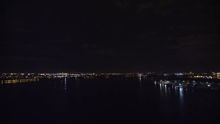 Aerial view of night lights on a city next to a river