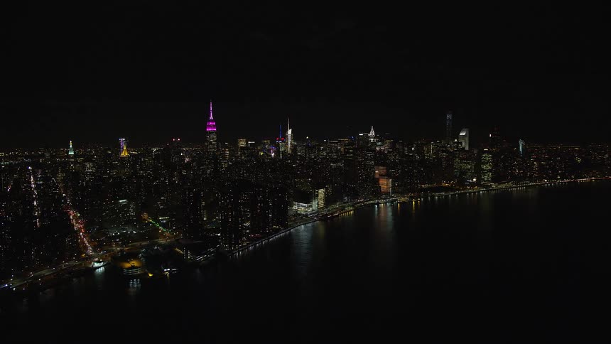 Aerial panorama of a nighttime metropolis by the seaside