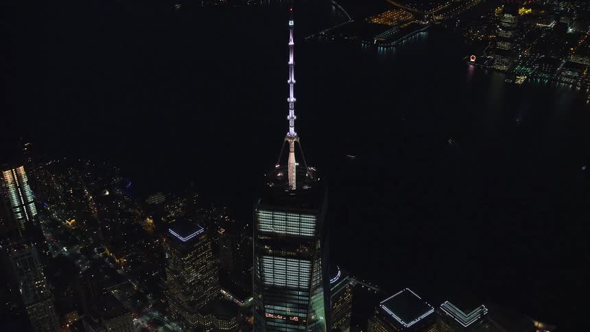 Aerial view of a tower with bright lights at night