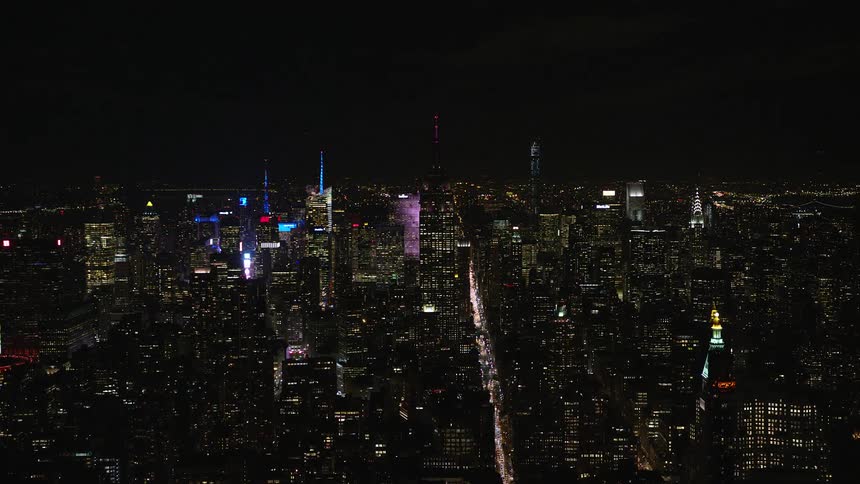 Buildings and moving cars in a metropolitan area at night