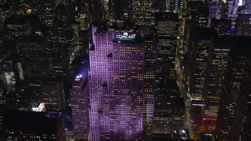 Aerial of the comcast building illuminated at night
