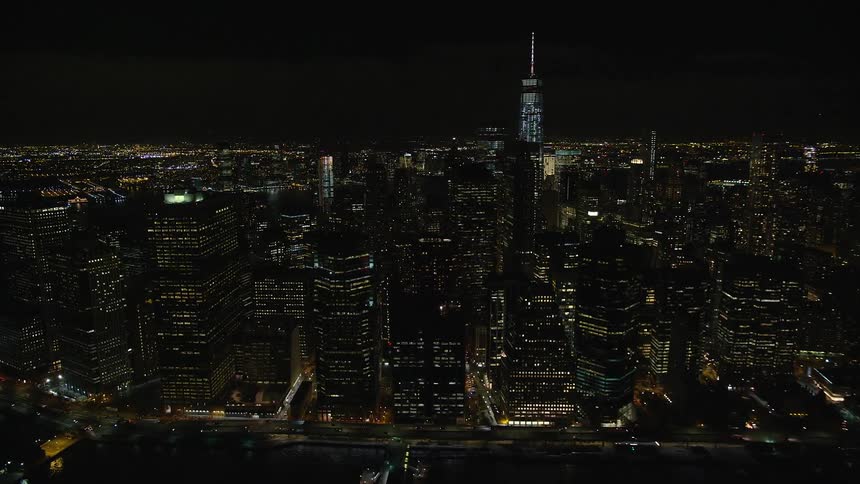 Aerial view and panorama of skyscrapers at night by the seaside