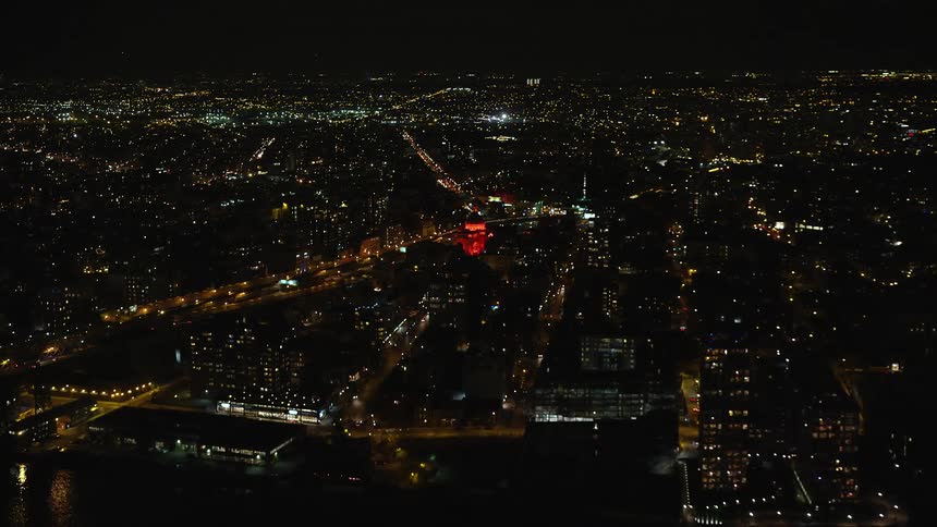 Aerial of city coastline with skyscrapers at night