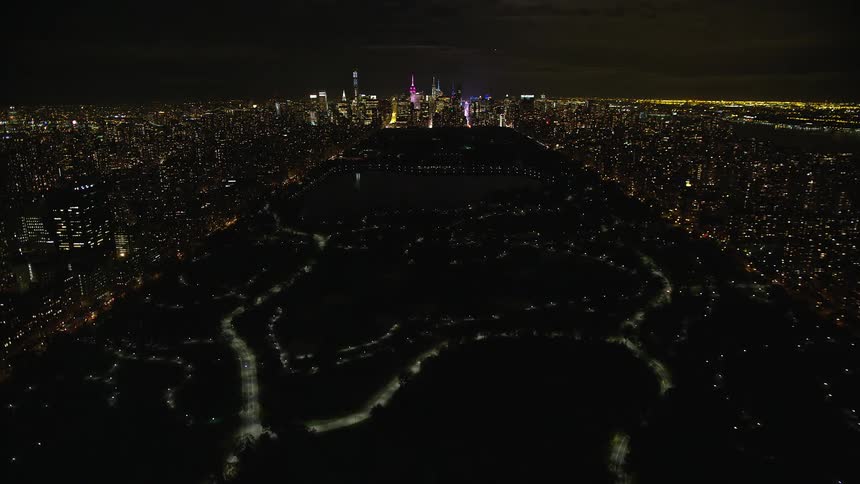 Panorama of a nighttime park in the midst of a metropolis