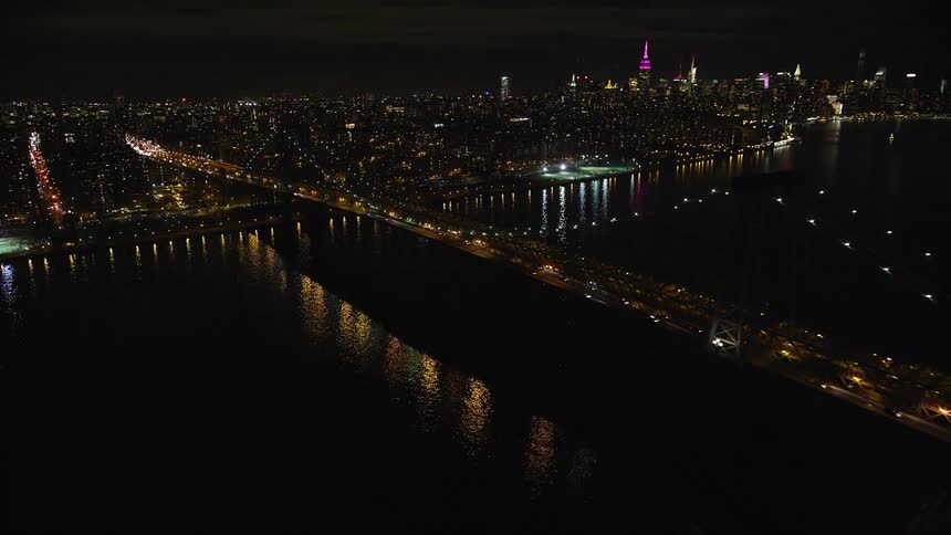 A bridge over a river in new york city at night