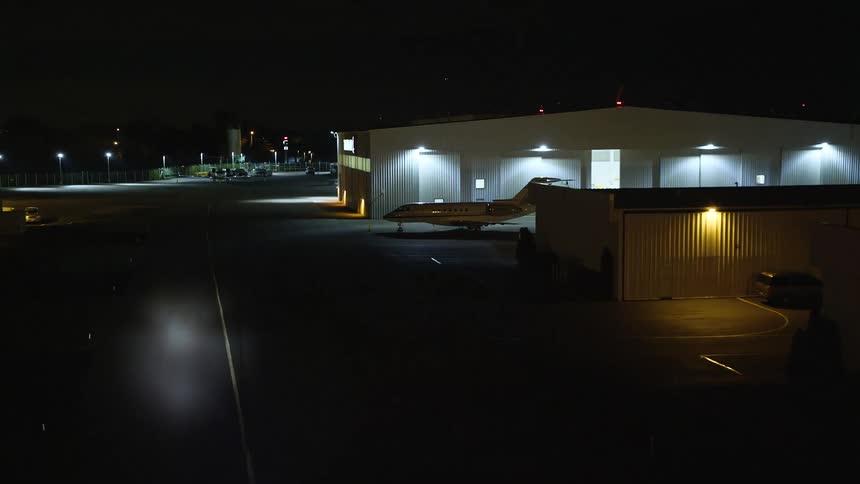 A night view of a jet in an harbor