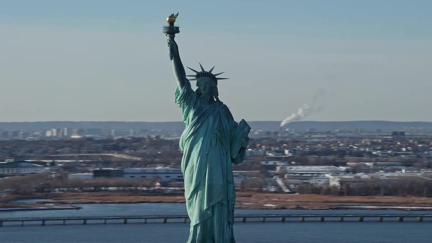 The statue of liberty which is surrounded by a sea