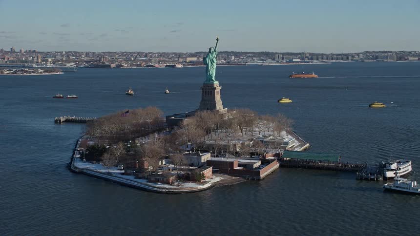 Aerial panorama of the statue of liberty on an island in the middle of the sea