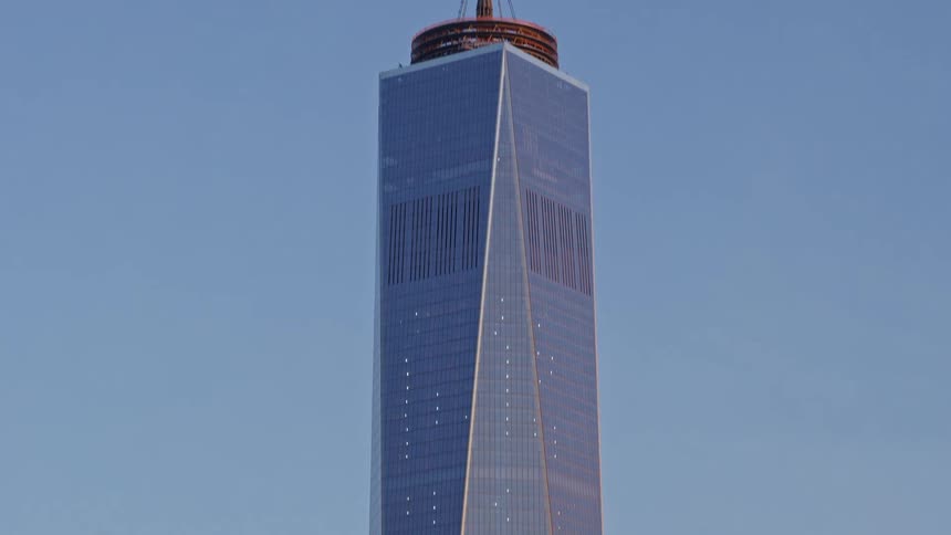 A huge glass building in a city center