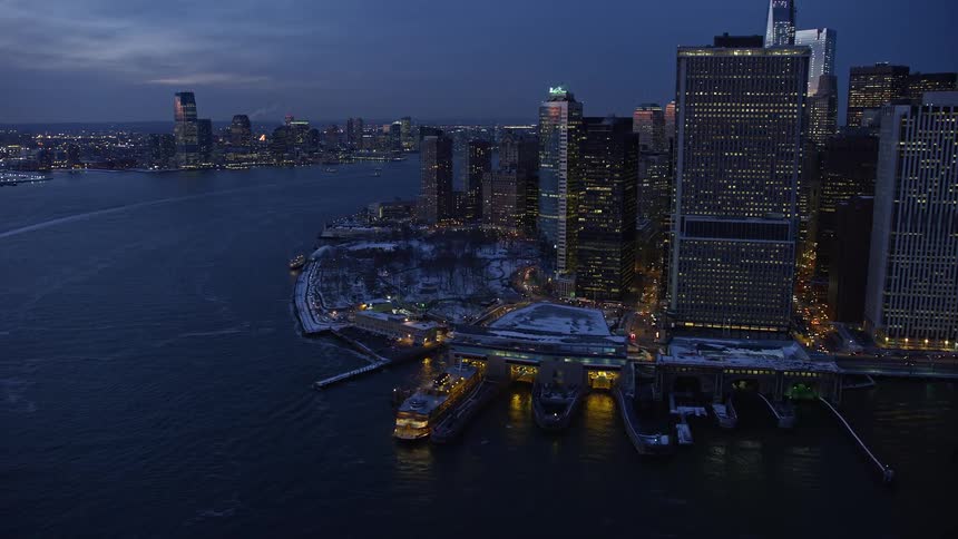 Aerial panorama of a metropolis by the seaside at night with yachts parked