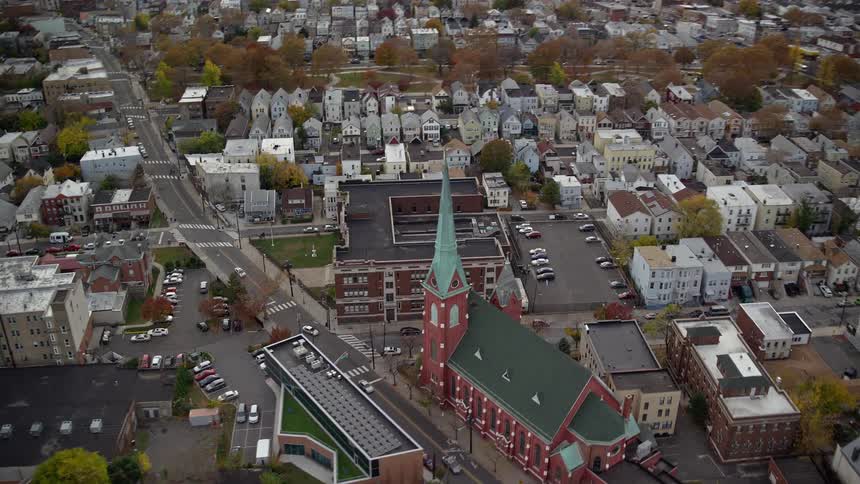 Aerial and panoramic view of an urban and residential city with a central church by the seaside