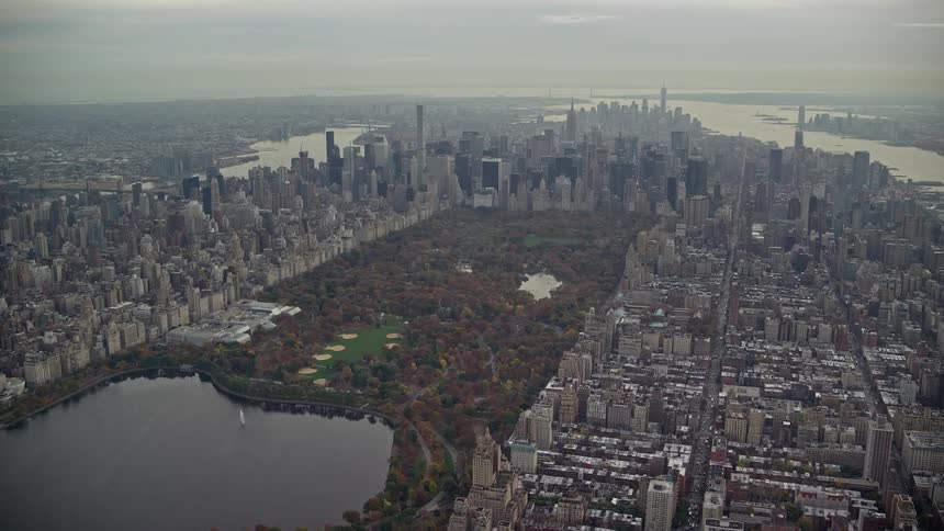 An aerial view of new yorks central park with several trees and a lake