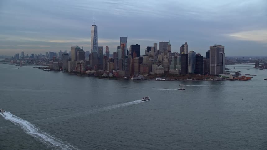 The boats travel past the city