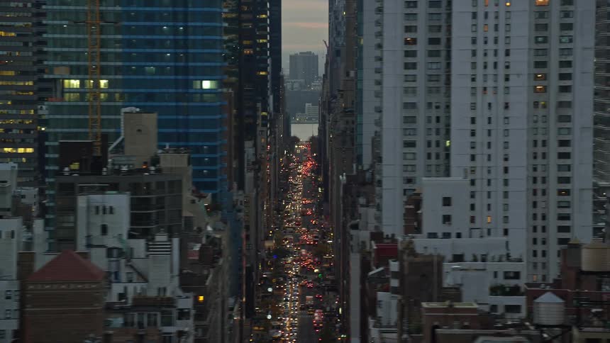 A city with tall buildings and streets with traffic jams