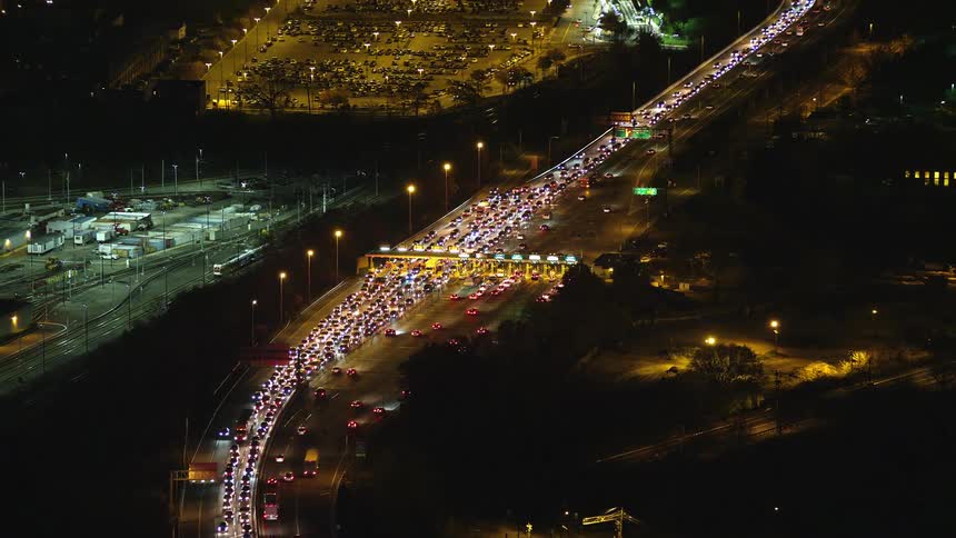 Aerial and panoramic view of a nighttime highway with traffic