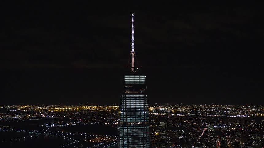 Aerial view of a tower in a fully mirrored skyscraper at night