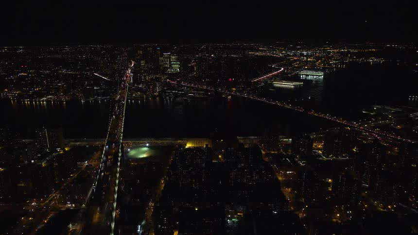 A night aerial view of a bridge liking two shorelines