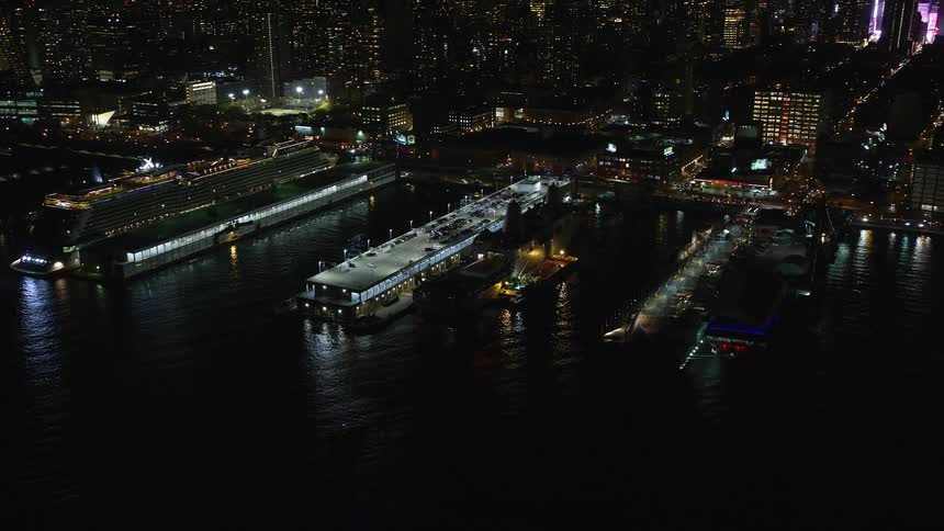 The harbor is brightly lit at night