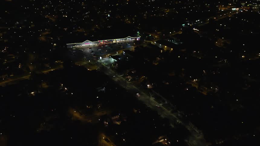 Cars are driving through town at night